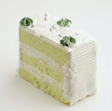 a slice of pandan cake with cream filling