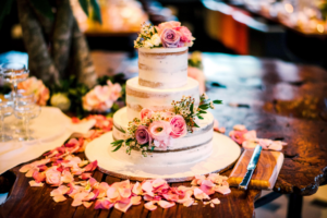 a vanilla cake with flowers decorated all around it