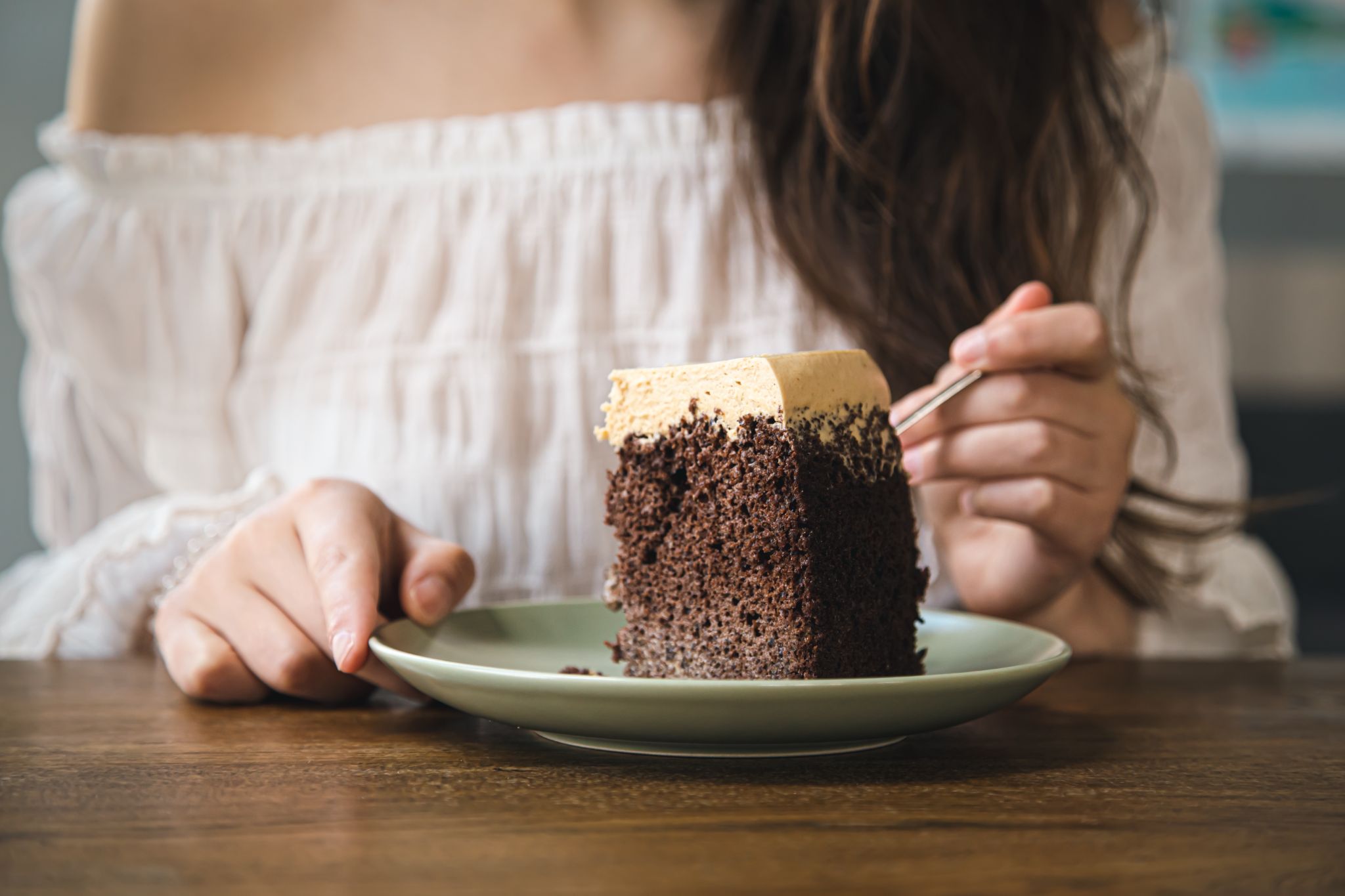 a woman enjoying a slice of cake