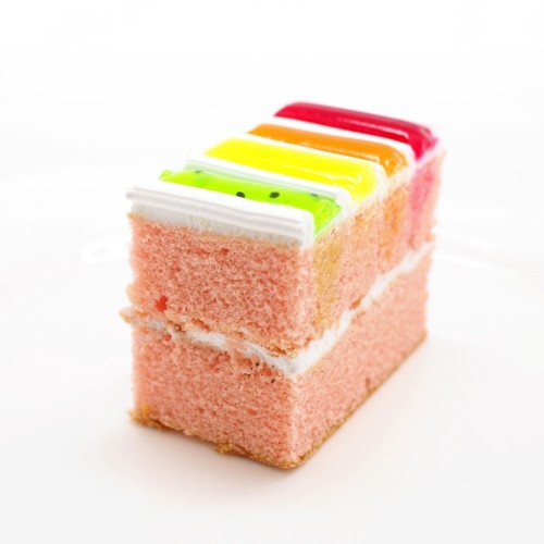 a slice of nostalgic old fashioned rainbow cake